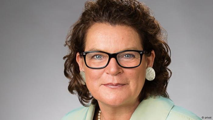 A portrait of. Dr. Claudia Brözel wearing glasses and looking at the camera.