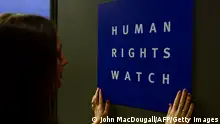 A woman puts a logo of US-based rights group Human Rights Watch on the door as she prepares the room before their press conference to release their annual World report on January 21, 2014 in Berlin. The United States is setting a dangerous example for the world with its sweeping surveillance programmes run by National Security Agency NSA, giving governments an excuse for mass censorship of online communications, Human Rights Watch says in its 2014 report.
AFP PHOTO / JOHN MACDOUGALL (Photo credit should read JOHN MACDOUGALL/AFP via Getty Images)