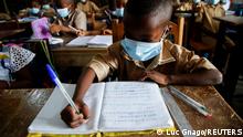 Students wearing protective masks, study in a classroom at the Merlan school in Paillet where, according to the director of the Pasteur Institut of Ivory Coast, professor Mireille Dosso, cases of the new Omicron variant of SARS-CoV-2 were detected, amid the outbreak of the coronavirus disease (COVID-19) in Abidjan, Cote d'Ivoire January 11, 2022. REUTERS/Luc Gnago
