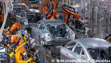 Metal car bodies pictured at an assembly line in a BMW factory