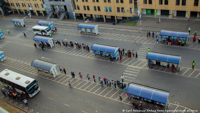 People queueing at a bus stop