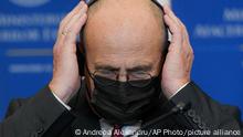 Poland's Foreign Minister Zbigniew Rau adjusts his headphones during joint statements with Romanian counterpart Bogdan Aurescu, in Bucharest, Romania, Tuesday, Nov.23, 2021. (AP Photo/Andreea Alexandru)
