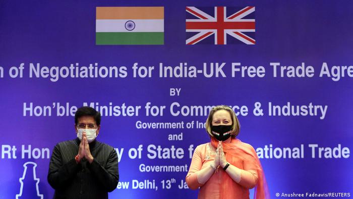 India's Minister of Commerce and Industry, Piyush Goyal, and British Secretary of State for International Trade Anne-Marie Trevelyan fold their hands during the launch of free trade agreement talks in New Delhi