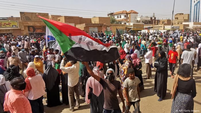 A Sudanese demonstrator waves a national flag during a protest in Khartoum against the October 2021 military coup