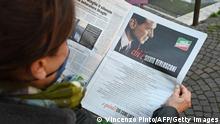 A woman reads on January 13, 2022 in Rome, a self-advertising page by former Italian prime minister, media tycoon and candidate for the upcoming presidential election, Silvio Berlusconi, in the daily newspaper Il Giornale that his family owns. - A hero of freedom who put an end to the cold war and an example for all Italians: Silvio Berlusconi has given himself a page of praise in a national newspaper, ten days before the presidential election in which he is a candidate. (Photo by Vincenzo PINTO / AFP) (Photo by VINCENZO PINTO/AFP via Getty Images)