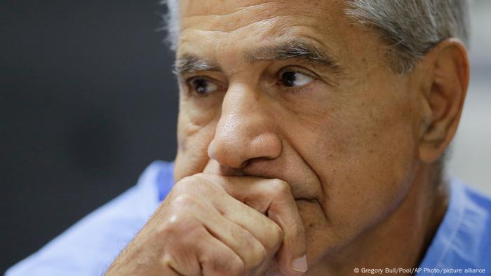 Sirhan Sirhan with is hand over his mouth