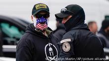 People wearing hats and patches indicating they are part of Oath Keepers attend a rally at Freedom Plaza Tuesday, Jan. 5, 2021, in Washington, in support of President Donald Trump. (AP Photo/Jacquelyn Martin)
