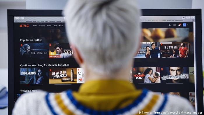 A woman looking at Netflix on her desktop