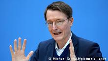 German Health Minister Karl Lauterbach speaks during a press conference on the current coronavirus pandemic in Berlin, Germany, Friday, Jan. 14, 2022. (AP Photo/Michael Sohn)