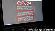 A laptop screen displays a warning message in Ukrainian, Russian and Polish, that appeared on the official website of the Ukrainian Foreign Ministry after a massive cyberattack, in this illustration taken January 14, 2022. REUTERS/Valentyn Ogirenko/Illustration