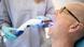 UV light being used at a dentist's to harden material in a person's mouth UV light being used at a dentist's to harden material in a person's mouth