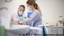 dentist and assistant giving treatment