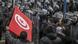 Protesters hold the Tunisian flag as they stand in front of security forces Protesters hold the Tunisian flag as they stand in front of security forces