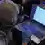 An FSB officer checks a laptop of a detained hacker