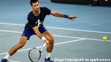 Serbian tennis player Novak Djokovic practices at Melbourne Park as questions remain over the legal battle regarding his visa to play in the Australian Open in Melbourne, Australia, January 14, 2022. AAP Image/Diego Fedele via REUTERS ATTENTION EDITORS - THIS IMAGE WAS PROVIDED BY A THIRD PARTY. NO RESALES. NO ARCHIVE. AUSTRALIA OUT. NEW ZEALAND OUT
