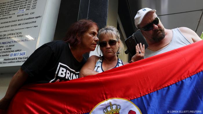 Supporters of Serbian tennis player Novak Djokovic listen to the court hearing at the offices of his legal team Supporters of Serbian tennis player Novak Djokovic listen to the court hearing at the offices of his legal team