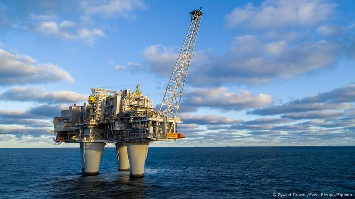 Gas production platform in the sea with crane boom 