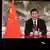 Chinese President Xi Jinping is seen on a TV screen speaking remotely at the opening of the WEF Davos Agenda virtual session