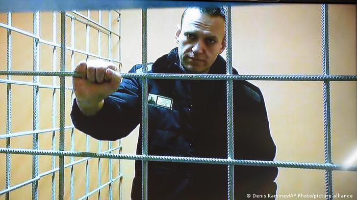 Russian opposition leader Alexei Navalny looks at a camera while speaking from a prison via a video link, provided by the Russian Federal Penitentiary Service