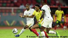 Cameroon's forward Clinton Njie (C) fights for the ball with Cape Verde's defender Dylan Tavares (L) and Cape Verde's defender Stopira (R) during the Group A Africa Cup of Nations (CAN) 2021 football match between Cape Verde and Cameroon at Stade d'Olembe in Yaounde on January 17, 2022. (Photo by Kenzo Tribouillard / AFP) (Photo by KENZO TRIBOUILLARD/AFP via Getty Images)