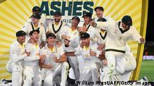 Australia's players celebrates with the trophy after defeating England on the third day of the fifth Ashes cricket Test match in Hobart on January 16, 2022. - - -- IMAGE RESTRICTED TO EDITORIAL USE - STRICTLY NO COMMERCIAL USE -- (Photo by William WEST / AFP) / -- IMAGE RESTRICTED TO EDITORIAL USE - STRICTLY NO COMMERCIAL USE -- (Photo by WILLIAM WEST/AFP via Getty Images)