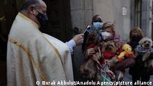 MADRID, SPAIN - JANUARY 17: Dogs is blessed by a priest during the animal blessing at San Anton Church in Madrid, Spain on 17 January 2022. During the San Anton Day people brigng their pets to the church around the country to have their animals blessed. Burak Akbulut / Anadolu Agency