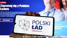 Polish Deal logo is displayed on a mobile phone screen photographed with Polish Deal website on the background for illustration photo. Krakow, Poland on May 16, 2021. Polish Deal, an economic package for recovery from the pandemic, was presented during PiS (Law and Justice) ruling party convention on Saturday. The programme will cover areas such as healthcare, the environment, homebuyers, pensioners, schooling and extended support for parents. (Photo by Beata Zawrzel/NurPhoto)