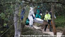 Police officers carry the remains of a person who was found on the hillside pilgrimage site Monserrate, known as one of the city's most-emblematic tourist spots, in Bogota, Colombia, Thursday, Dec. 3, 2015. National Police said they have recovered the remains of nine persons whose bodies were dumped in Monserrate. Police announced the grisly discovery last Tuesday after being led to the site by a man who confessed to murdering seven women. Authorities are searching the area for more bodies. (AP Photo/Fernando Vergara)