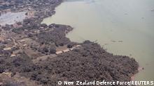 A general view from a New Zealand Defence Force P-3K2 Orion surveillance flight shows ash covered homes and vegetation over Nomuka in Tonga after the Pacific island nation was hit by a tsunami triggered by a massive undersea volcanic eruption January 17, 2022. Picture taken January 17, 2022. New Zealand Defence Force/Handout via REUTERS ATTENTION EDITORS - THIS IMAGE WAS PROVIDED BY A THIRD PARTY. NO RESALES. NO ARCHIVE. TPX IMAGES OF THE DAY 