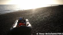 An inflatable dinghy used by migrants to cross the English Channel lies abandoned on the beach in Dungeness, Britain, January 18, 2022. REUTERS/Henry Nicholls 