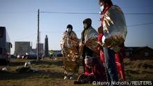Migrants stand on the beach after crossing the English Channel in an inflatable dinghy, in Dungeness, Britain, January 18, 2022. REUTERS/Henry Nicholls 