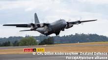 In this photo provided by the New Zealand Defence Force, a Royal New Zealand Air Force C-130 Hercules leaves an airbase in Auckland, Thursday, Jan. 20, 2022, flying to Tonga with aid. The first flight carrying fresh water and other aid to Tonga was finally able to leave Thursday after the Pacific nation's main airport runway was cleared of ash left by a huge volcanic eruption. (CPL Dillon Anderson/New Zealand Defence Force via AP)