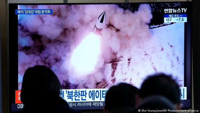 People watch a TV showing a file image of North Korea's missile launch shown during a news program at the Seoul Railway Station in Seoul, South Korea on January 20
