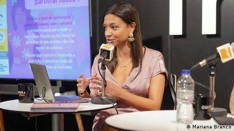 Inês Marinho an activist from Portugal is seen talking about online crime at an event.
