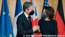 Secretary of State Antony Blinken, left, fist bumps German Foreign Minister Annalena Baerbock, before their meeting at the Ministry of Foreign Affairs, Thursday, Jan. 20, 2022, in Berlin, Germany. (AP Photo/Alex Brandon, Pool)