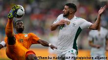 Algeria's Said Benrahma, right, watches on as Ivory Coast's Serge Aurier kicks the ball during the African Cup of Nations 2022 group E soccer match between Ivory Coast and Algeria at the Japoma Stadium in Douala, Cameroon, Thursday, Jan. 20, 2022. (AP Photo/Themba Hadebe)