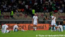 Dejected Algeria players on the pitch after their elimination from AFCON