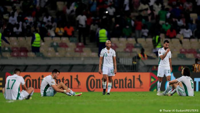 Dejected Algeria players on the pitch after their elimination from AFCON
