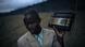A rman holding up a radio in the Democratic Republic of Congo A rman holding up a radio in the Democratic Republic of Congo