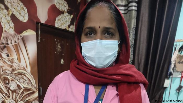 Suman Belhara, a 47-year-old accredited social health activist, wears a mask