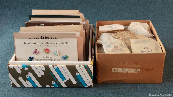 Nazi memorabilia, including pamphlets, medals and pins in boxes