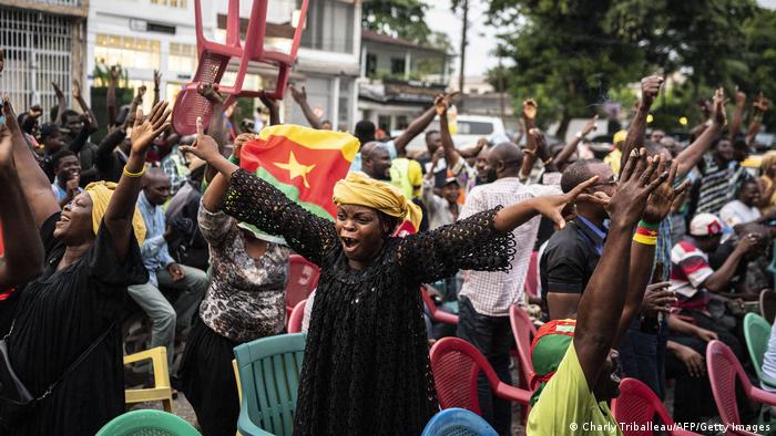 Celebrations on streets of Douala, Cameroon, with football fans with outstretched arms