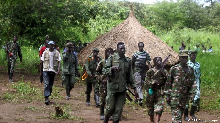 Lord's Resistance Army (LRA) fighters emerge from thick bush on the Sudan-DR Congo border