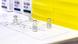 Four vials of vaccine sit on a white paper with technical indications Four vials of vaccine sit on a white paper with technical indications