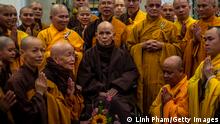 Buddhist monks greet Thich Nhat Hanh at the Tu Hieu temple