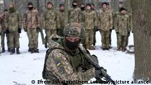 An instructor trains members of Ukraine's Territorial Defense Forces
