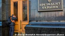 2385160 02/21/2014 A man looking through the glass door into the building of the Ukrainian presidental administration in downtown Kiev. The militia left the territory of the government quarter fulfilling the resolution of Ukrainian parliament. Andrey Stenin/RIA Novosti