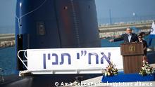 (140923) -- HAIFA, Sept. 23, 2014 () -- Israeli Prime Minister Benjamin Netanyahu (L) gives a speech next to an INS Tanin, a Dolphin AIP class submarine, during a ceremony upon its arrival at a naval base in the northern Israeli city of Haifa, on Sept. 23, 2014. The Israeli Navy on Tuesday welcomed the newest addition to its submarine fleet, INS Tanin, a fourth German-made vessel that military and defense officials say will dramatically boost Israel's ability to operate against foes near and far, local media reported. (/POOL/Amir Cohen)