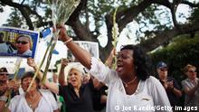 CORAL GABLES, FL - APRIL 27: Berta Soler, co-founder of the Ladies in White, and current leader of the Cuban opposition group leads a cheer as she visits with Cuban exiles during an event at Merrick Park on April 27, 2013 in Coral Gables, Florida. In Cuba Soler’s group is made up of wives and mothers and was formed in 2003 after the arrests of 75 government opponents. (Photo by Joe Raedle/Getty Images)