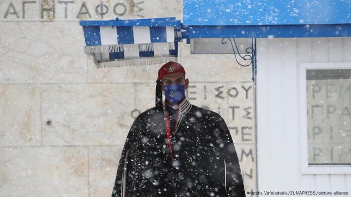 Presidential guard, known as Evzonas, stands guard during a heavy snowfall in the center of Athens